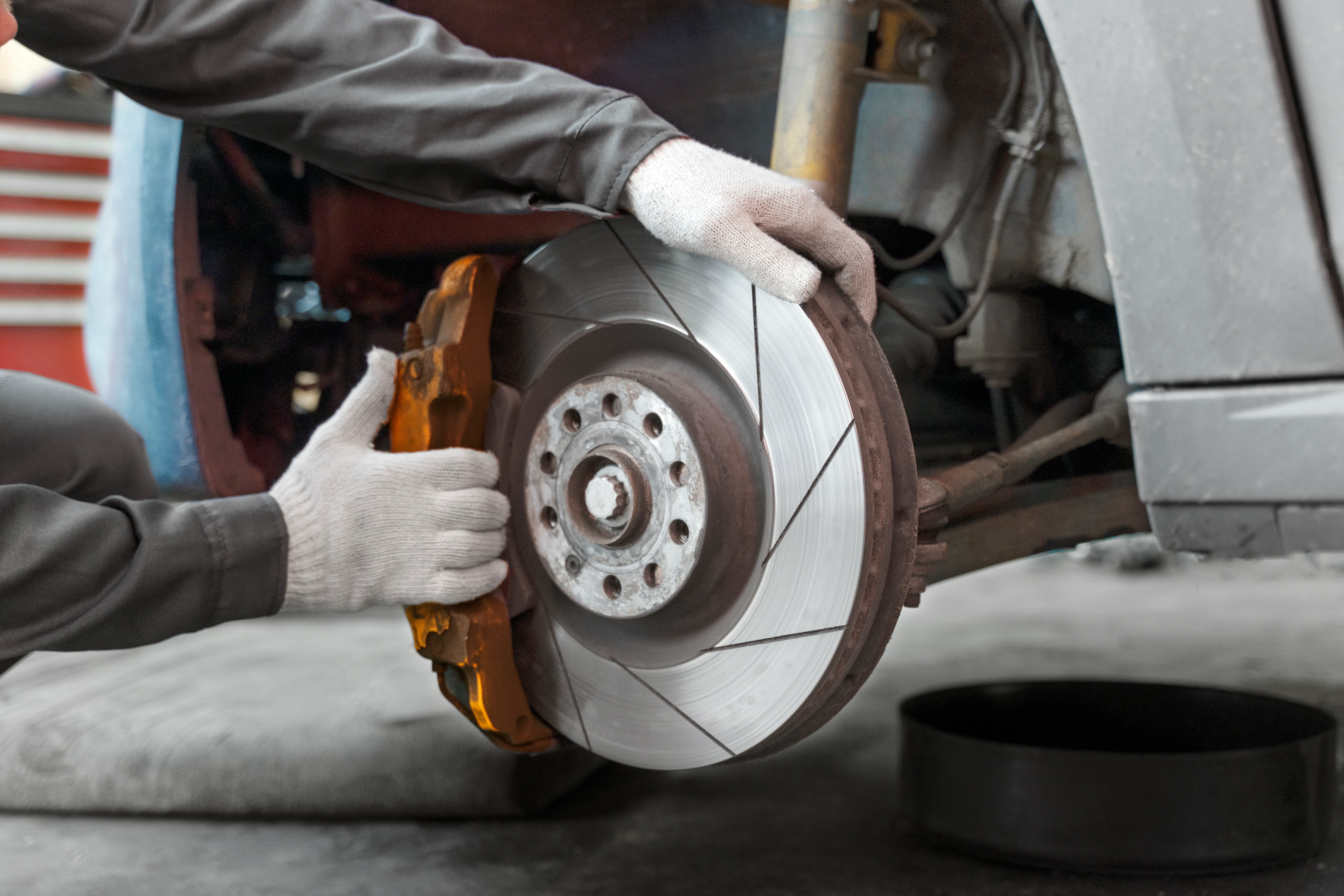 side view worker repairing car